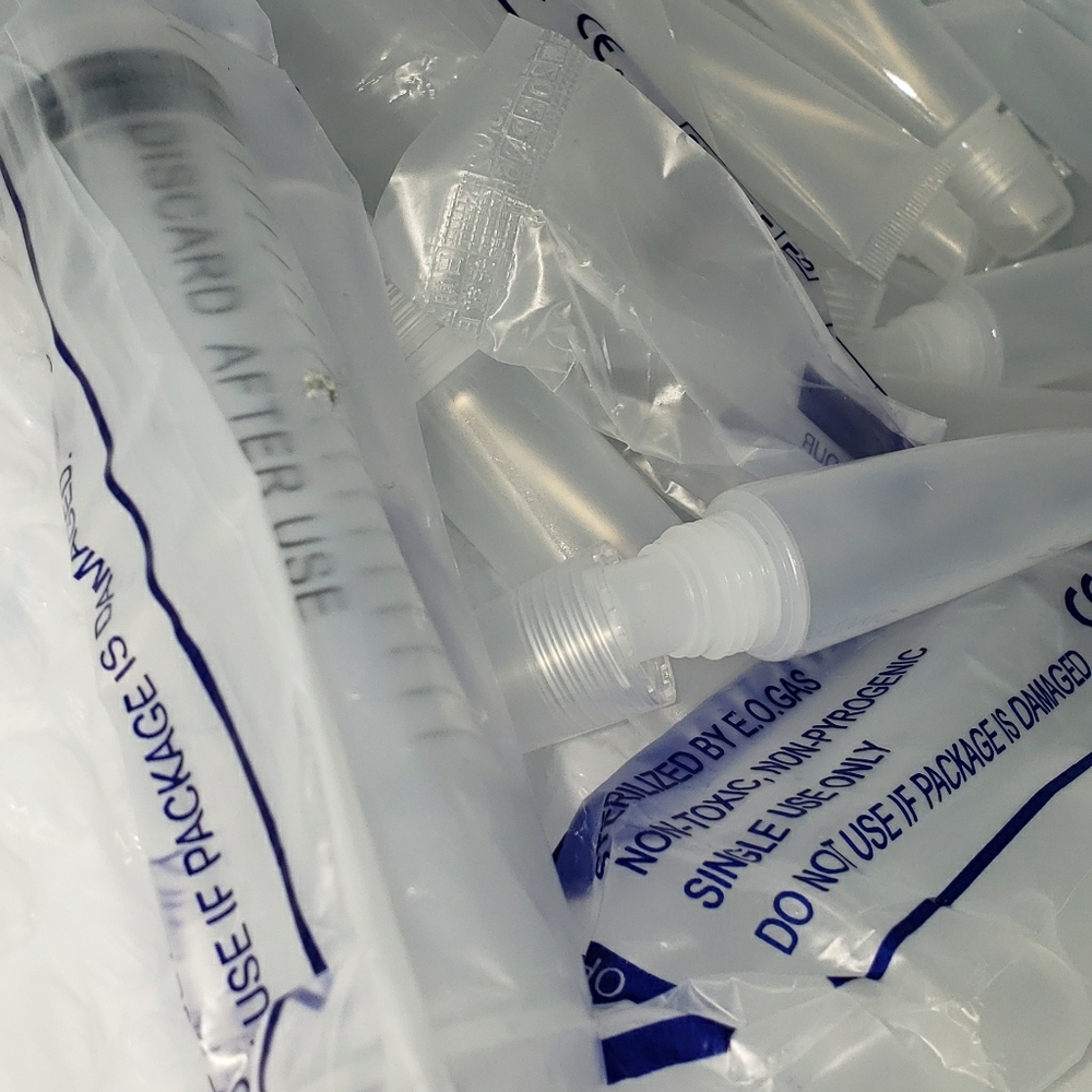 Lipgloss containers with syringes